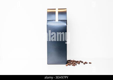 A dark green airtight box with coffee beans on a white surface. Stock Photo