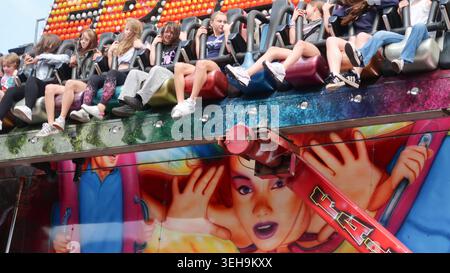 Young people on magic carpet fairground ride Stock Photo