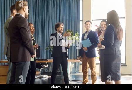 Business coach leads team workshop with corporate presentation in modern office Stock Photo