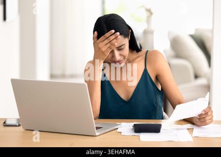 Woman feels stressed while managing home finances Stock Photo