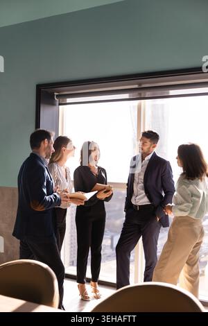 Group of diverse colleagues engaging in discussion Stock Photo