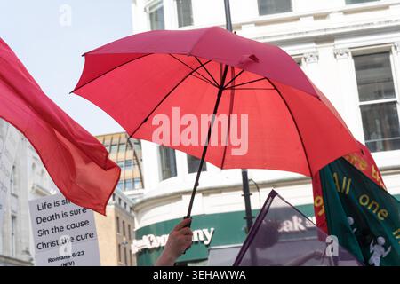 London, UK. 23rd May 2026. UK Weather,  The UK Health Security Agency issued its first amber heat-health alert of 2026 for London on 22 May, in place until 27 May, as temperatures were forecast to reach 30°C — potentially breaking the UK May temperature record. red umbrellas are held aloft by participants in the Ichthus Christian Fellowship Jesus March at Trafalgar Square, central London, on 23 May 2026, forming a collective canopy against the heatwave conditions Credit:xiu bao/Alamy Live News Stock Photo