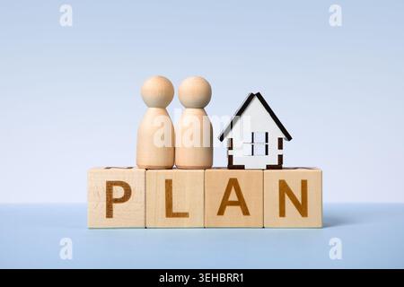 Wooden cubes with word plan with house and little people figures symbol of success. Development to success, planning and motivation, challenge and business strategy, business progress Stock Photo