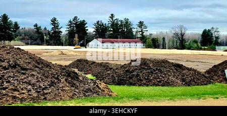 Workers with a contractor complete work April 24 2026, to construct a large parking area on the cantonment area for the at Wisconsin Maneuver Area Tra Stock Photo