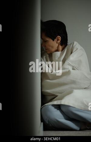 Middle Aged Woman Sitting Alone and Coping with Depression Stock Photo