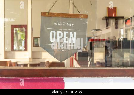 An open sign hanging before restaurant or cafe is welcoming customers. Stock Photo