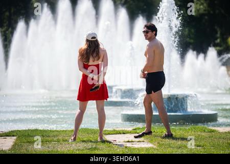 People walk near water fountains in Battersea Park, south west London. Temperatures will continue to climb throughout the weekend, as forecasters said the "exceptional heat" may break records for the warmest day in May and hottest bank holiday. Picture date: Sunday May 24, 2026. Stock Photo