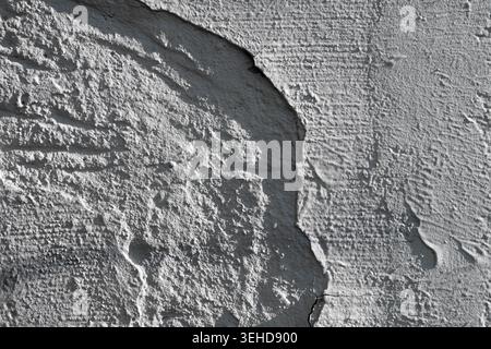 Texture of a grungy concrete wall with cracks and scratches which can be used as a background Stock Photo