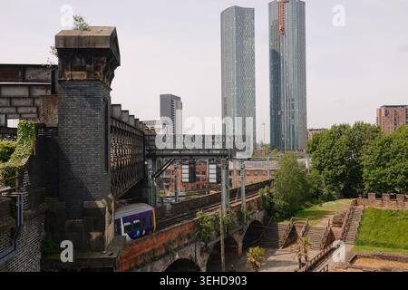 The historic Castlefield Viaduct and reconstructed Mamucium Roman Fort with Deansgate Square skyscrapers in Manchester, England, UK Stock Photo
