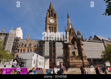 The historic Manchester Town Hall undergoing scaffolding restoration works behind the Albert Memorial at Albert Square in Manchester, England, UK Stock Photo