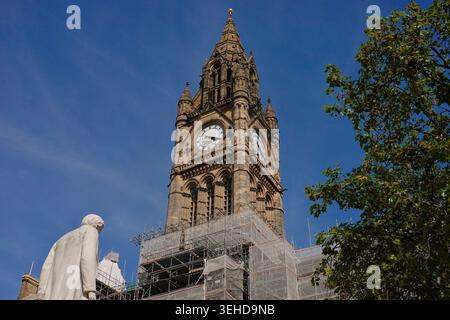 The statue of John Bright facing the scaffolded Manchester Town Hall clock tower during restoration works in Manchester, England, UK Stock Photo