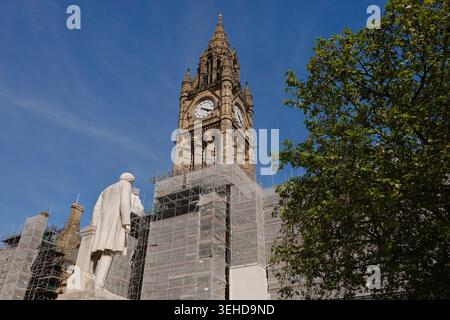The statue of John Bright facing the scaffolded Manchester Town Hall clock tower during restoration works in Manchester, England, UK Stock Photo