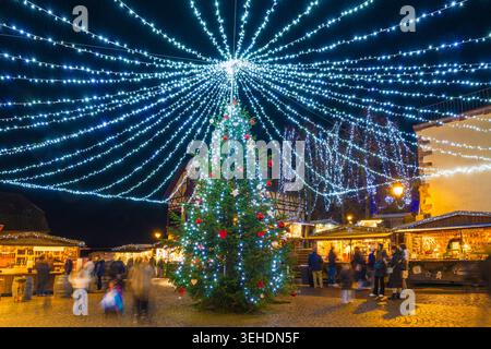 Colorfully illuminated and festively decorated half-timbered houses, blue hour, Christmas market, Riquewihr, Grand Est, Haut-Rhin, Alsace, France Stock Photo