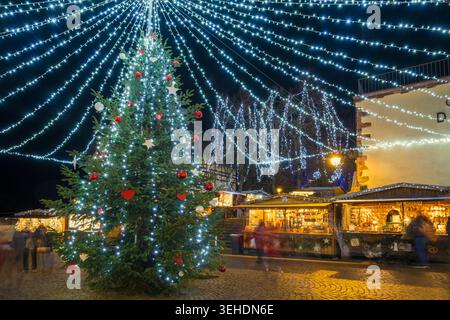 Colorfully illuminated and festively decorated half-timbered houses, blue hour, Christmas market, Riquewihr, Grand Est, Haut-Rhin, Alsace, France Stock Photo