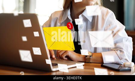 Person checks email on laptop while notifications display on screen Stock Photo