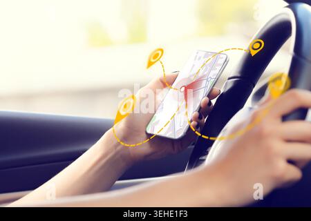 Person using a smartphone for taxi location on a map while driving Stock Photo