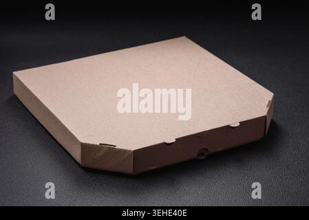 Food, Empty cardboard rectangular brown box for delivery of delicious pizza. Takeaway food packaging Stock Photo