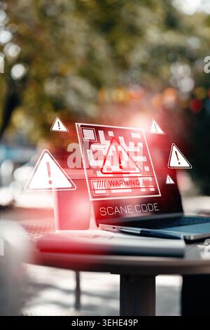 Scam message warning displayed on a laptop screen in an outdoor setting Stock Photo