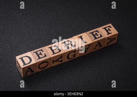 Food, The inscription debrief in wooden cubes on a dark concrete background. Can be used as part of your composition Stock Photo