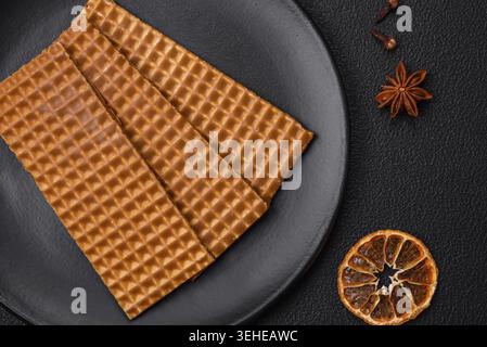 Food, Delicious sweet crispy rectangular waffles on a ceramic plate on a dark concrete background Stock Photo