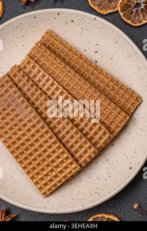 Food, Delicious sweet crispy rectangular waffles on a ceramic plate on a dark concrete background Stock Photo