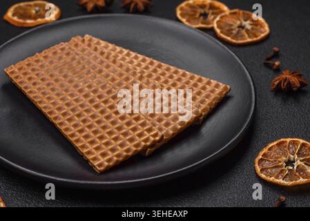 Food, Delicious sweet crispy rectangular waffles on a ceramic plate on a dark concrete background Stock Photo
