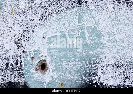 Weathered Wall Texture with Exposed Brick and Peeling Paint Stock Photo