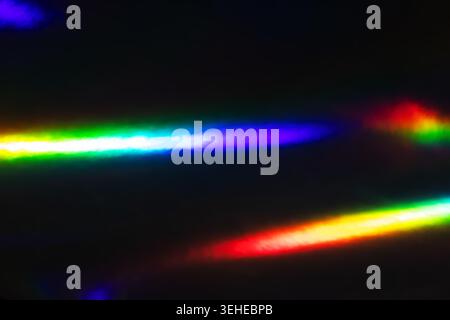 Abstract Rainbow Light Streaks on Dark Background: Colorful Spectrum Reflections Stock Photo