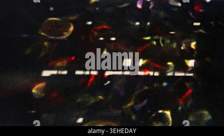 Abstract Light Refractions on Dark Surface Creating Colorful Patterns Stock Photo