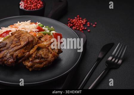 Food, Delicious boiled rice with peppers, peas, asparagus beans and carrots and fried chicken on a textured concrete background Stock Photo