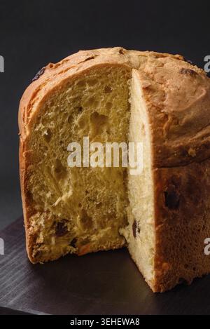 Food, Easter cake or panettone with raisins and candied fruits on a dark concrete background Stock Photo