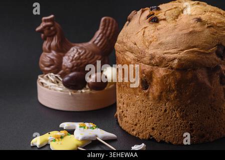 Food, Easter cake or panettone with raisins and candied fruits on a dark concrete background Stock Photo