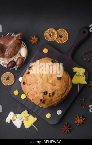 Food, Easter cake or panettone with raisins and candied fruits on a dark concrete background Stock Photo