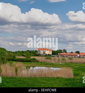 Residential area near the Oset nature reserve in Örebro, Sweden, with wetlands, reeds and dramatic clouds over the landscape. Stock Photo