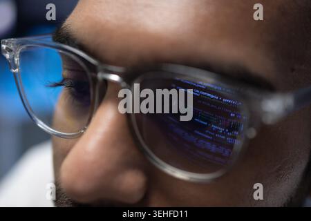 Indian Software Developer Wearing Glasses With Code Reflection On Lens Stock Photo