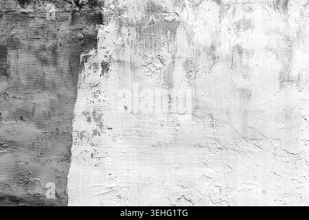 Grungy white plaster wall texture with cracks and peeling paint for backgrounds and urban patterns Stock Photo