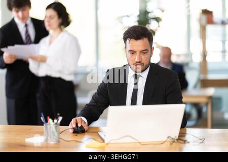 Business adult man concentrating on tasks while working at computer in office Stock Photo