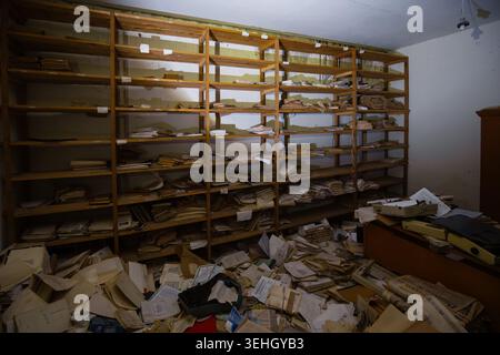 Abandoned archive room. Old documents on shelves. Stock Photo
