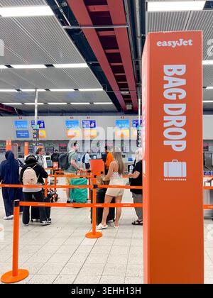 EasyJet customers queue at the bad drop to drop off their luggage at Luton London Airport in The UK Stock Photo