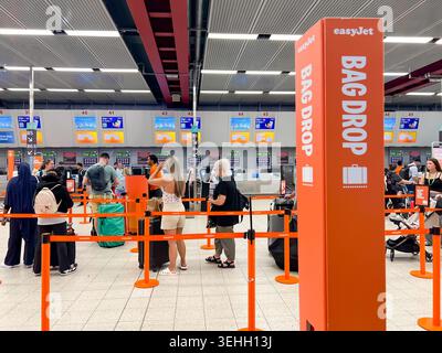 EasyJet customers queue at the bad drop to drop off their luggage at Luton London Airport in The UK Stock Photo