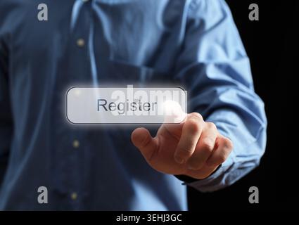 Businessman's hand touching a transparent touch screen button with the word register, representing online sign up and account creation Stock Photo