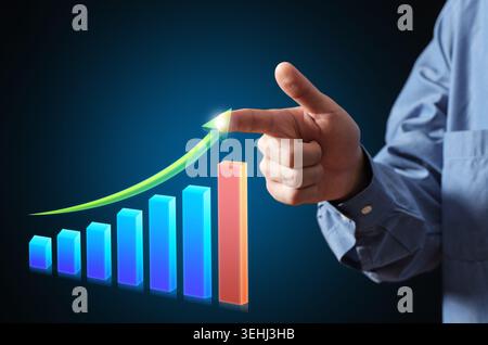 Business person hand touching an illuminating arrow showing increasing financial gain and economic growth on a graph Stock Photo