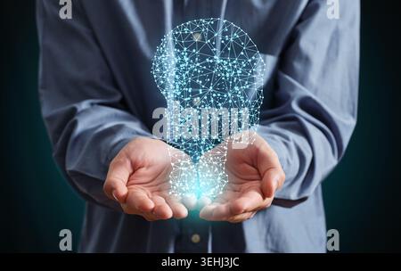 Person's hands cupping a glowing light bulb made of interconnected lines and dots, symbolizing artificial intelligence, machine learning, innovation a Stock Photo