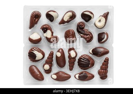 Brown and white chocolates in plastic package isolated on white background Stock Photo