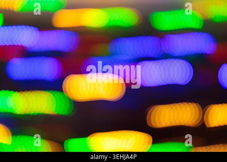 Colorful bokeh lights with vibrant glowing dots on dark background for festive celebration backdrop Stock Photo