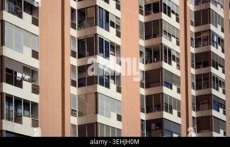 Close view of urban residential apartments with repeating balconies and window patterns Stock Photo