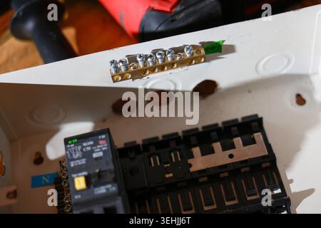 Close up view of electrical panel box breaker switch board ground bar component installation repair maintenance construction focus wire connection equ Stock Photo