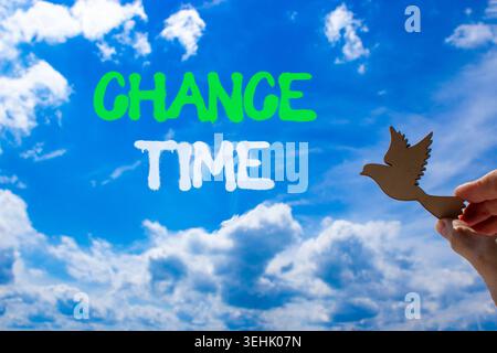 Chance time symbol. Concept word Chance time on beautiful blue sky. Businessman's hand with wooden bird. Beautiful blue sky and cloud background. Busi Stock Photo