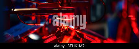 Automated machine vision inspection system checking screw quality with red LED light in factory Stock Photo