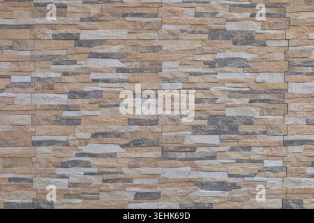 Brown, black and white porcelain stoneware coating wall with stone effect. Full frame.  Background and texture. Stock Photo
